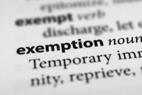 Close up image of the word "exemption" in a dictionary