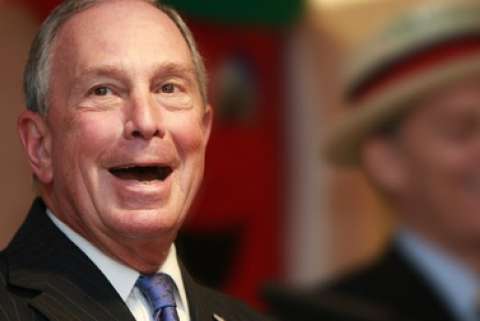 Former New York City mayor Michael Bloomberg smiles with his mouth open wide