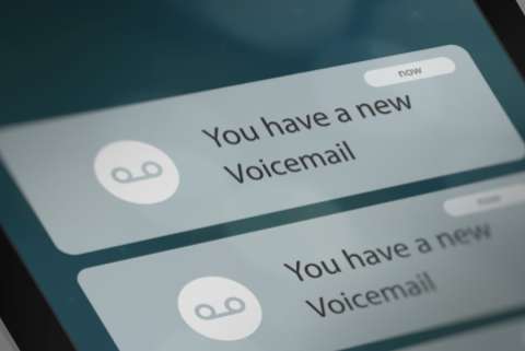 Close up image of a smartphone screen displaying notifications about new voicemail