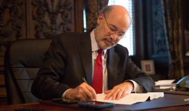 Pennsylvania Governor Tom Wolf signing a bill into law