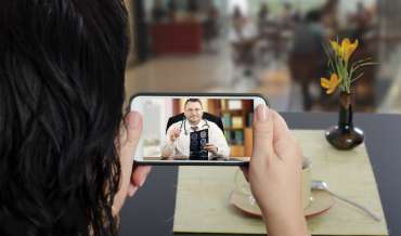 A woman consulting a doctor over videochat on a smartphone