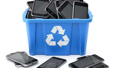 smart phones in a blue recycling bin