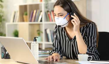 woman wearing mask working from home