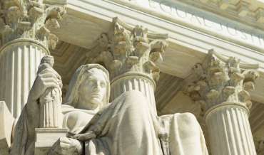 A statue in front of the United States Supreme Court