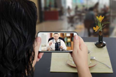 A woman consulting a doctor over videochat on a smartphone