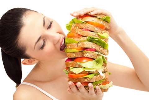 woman eating gigantic sandwich