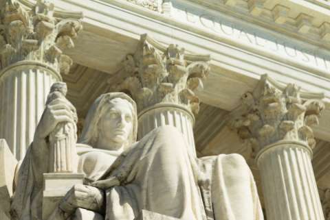 A statue in front of the United States Supreme Court