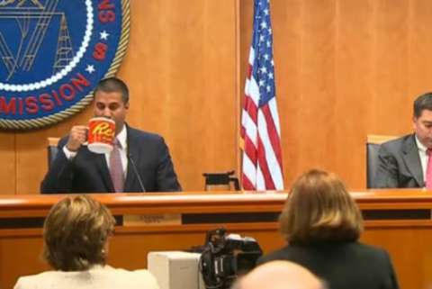 FCC Chairman Ajit Pai Drinks from a large mug with the Reese's peanut butter cup logo