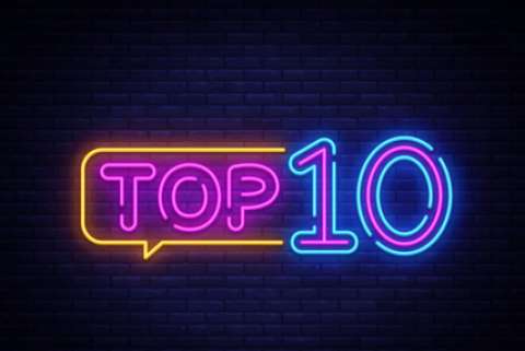 An illustration of the phrase "Top 10" rendered as if it were a neon sign against a brick background