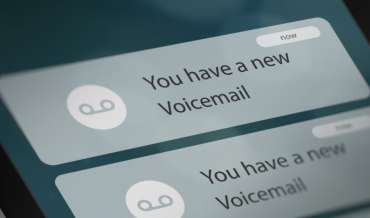 Close up image of a smartphone screen displaying notifications about new voicemail